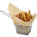 A basket lined with a Choice natural kraft liner filled with french fries.