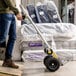 A person pushing a Gorilla convertible hand truck with a stack of boxes.