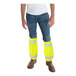 A man wearing Cordova Class E Hi-Vis Lime mesh leg gaiters over yellow pants and a yellow safety vest.