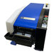 A blue and black Sealer Sales electric gummed kraft tape dispenser with a white tray and buttons.