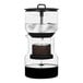 A Bruer black coffee maker with a black base and glass top.