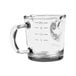 A clear glass Rhino Coffee Gear shot glass with a measuring scale.