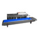 A close-up of a Sealer Sales band sealer with a blue belt.