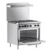 A Wolf stainless steel commercial range with 6 burners and an oven.