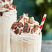 A close up of a chocolate bar with KIT KAT Chopped Bars on top of a dessert.