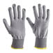 A pair of gray cut-resistant, food-safe gloves with ribbed cuffs and yellow trim.