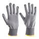 A pair of gray cut-resistant gloves with ribbed cuffs and yellow trim, designed for food-safe use.