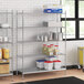 A stainless steel wire shelving unit with solid stainless steel shelves.