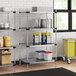 Regency galvanized steel shelving in a kitchen with white and blue plastic containers.