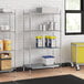 A Regency metal wire shelving unit in a kitchen with containers on it.
