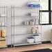 A stainless steel wire shelf kit with solid stainless steel shelves in a professional kitchen.