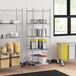 A Regency chrome wire shelving unit with a galvanized steel bottom shelf in a school kitchen.