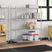 Regency chrome wire shelving in a kitchen with white and blue plastic containers on the bottom shelf.