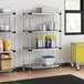 A Regency galvanized steel shelf with containers on it, including blue and yellow containers.