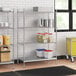 A stainless steel wire shelf kit with solid stainless steel shelves holding food containers.