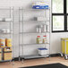 A Regency metal wire shelving unit in a professional kitchen with food items on the shelves.