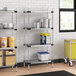 Regency galvanized steel shelves in a school kitchen with food items on them.