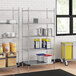 A Regency chrome wire shelving unit in a kitchen with pots and pans on the shelves.