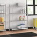 Stainless steel wire shelf kit with solid stainless steel bottom in a kitchen with containers on the shelves.