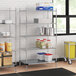 Regency chrome wire shelving with a solid metal bottom shelf in a kitchen with food items on it.