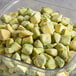 A clear plastic container filled with Dole Chef-Ready Cuts IQF Diced Avocado.