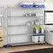 A Regency chrome wire shelving unit in a kitchen with a solid metal bottom shelf.
