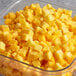 A glass bowl filled with Dole Chef-Ready Cuts IQF cubed mango.