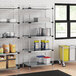 Regency galvanized steel shelves in a school kitchen with food items on them.