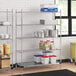 Regency chrome wire shelving in a kitchen with white and red plastic containers.