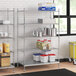 A stainless steel wire shelf kit with solid stainless steel shelves holding containers.