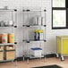 Regency galvanized steel shelves in a kitchen with containers on them.