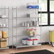 A stainless steel wire shelving unit with solid stainless steel shelves.