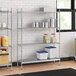 A stainless steel wire shelving unit with solid stainless steel shelves.