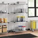 A four-shelf galvanized steel shelving unit with 74-inch posts, used for storage in a commercial kitchen or pantry.