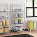Regency chrome wire shelving in a professional kitchen with white and blue storage containers on metal shelves.