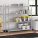 Stainless steel wire shelf kit with solid stainless steel bottom shelves on 64" posts.