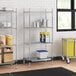 A Regency metal wire shelving unit in a kitchen with food containers on the bottom shelf.
