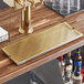 A Regency PVD gold metal surface-mount beer drip tray on a bar counter.