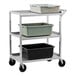 A New Age aluminum utility cart with three shelves holding plastic containers.
