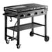 A black Backyard Pro liquid propane outdoor griddle with folding legs on a table.