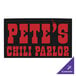 A black mat with a purple and black square with white text and a chili pepper logo in the middle.