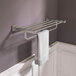 An American Standard Town Square S brushed nickel train rack with a towel on it.