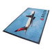 A blue and black rectangular WaterHog Impressions logo mat with a delta logo.
