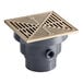 A grey floor drain with a square nickel bronze strainer.