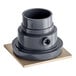 A grey plastic Sioux Chief floor drain with a square surface and a hole in it.