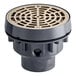 A Sioux Chief light-duty floor drain with a round nickel bronze strainer over a grey circular base.