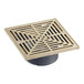 A square metal drain cover with a bronze grid.