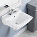 A white American Standard Declyn wall-mount sink with a silver faucet above it.
