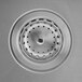 A close up of a stainless steel sink drain with holes from an American Standard Portsmouth sink.
