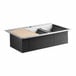 A stainless steel American Standard Chive workstation sink with a black cutting board over one bowl.